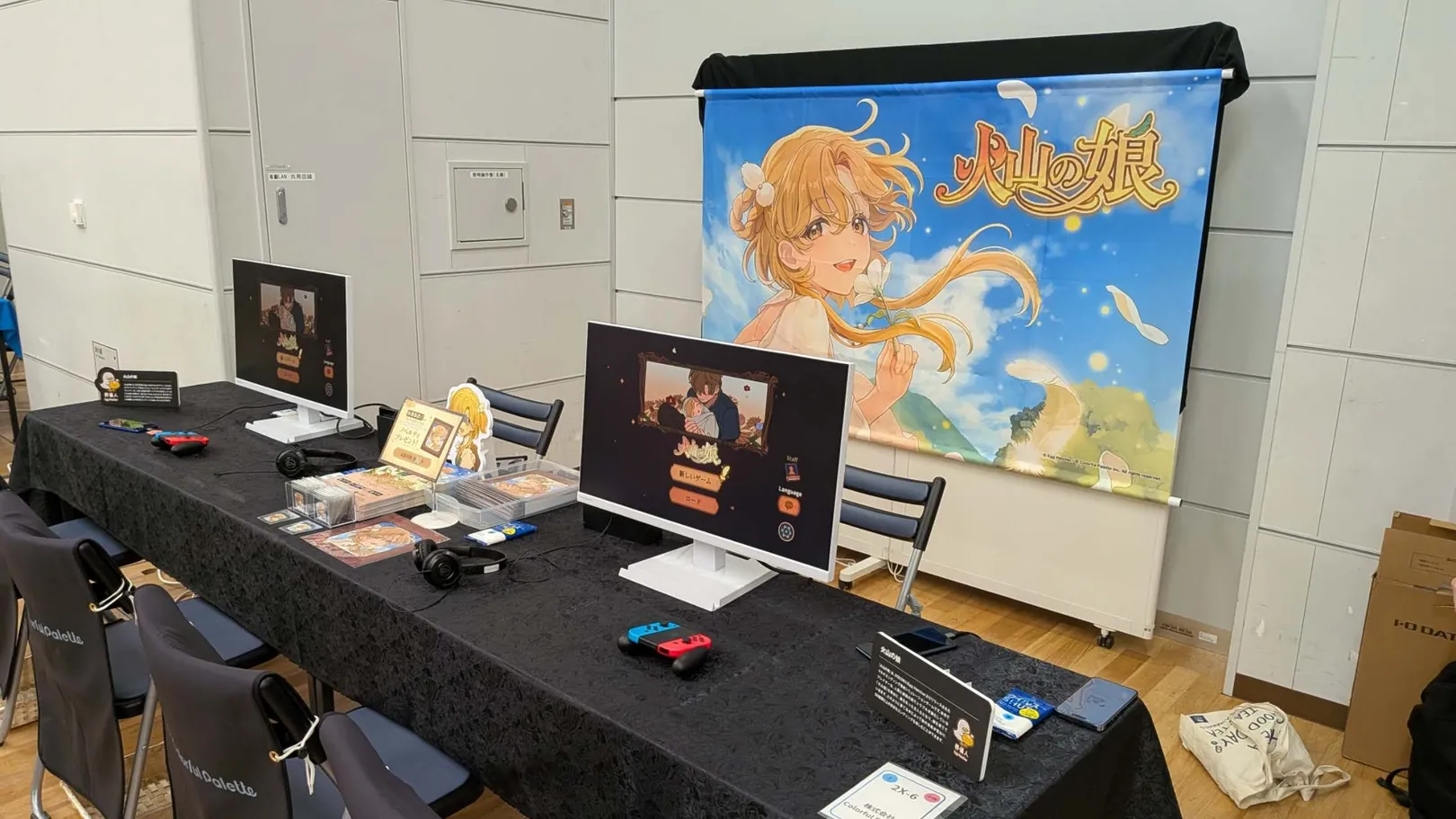 Flyers, a character standee and giveaway goods laid out on the table.