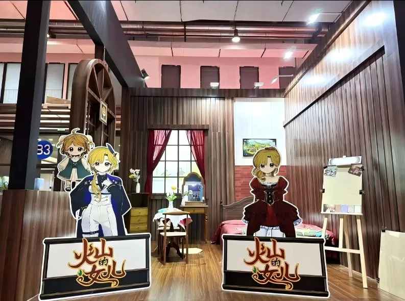 A furnished room set built for the show, with Volcano Princess character standees at the entrance.